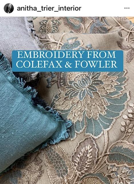 Broderi fra Colefax & Fowler med tekstil i blå og grå nyanser og en blå pute i fokus.