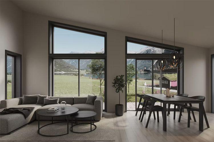 Moderne stue med store vinduer, sofa, spisebord og utsikt over fjell og grønt landskap.