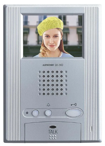 Dørtelefon med skjerm som viser en kvinne med en gul lue og smilende ansikt.