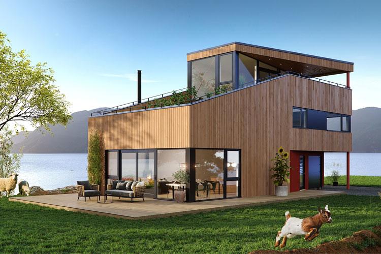Moderne trehus med store vinduer, terrasse og hund som leker i hagen ved vannet.