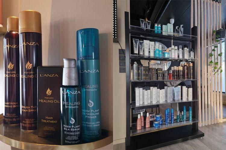 Hyller med hårprodukter fra Lanza, inkludert sjampo, balsam og stylingprodukter i en moderne salong.