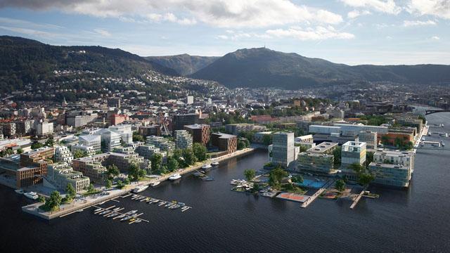 Futuristisk byutvikling ved vannkanten med moderne bygninger og båter i havnen, omgitt av fjell.