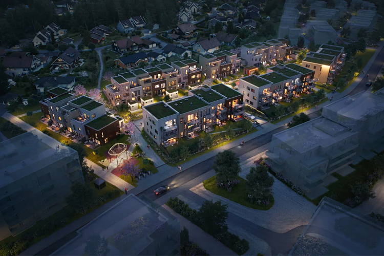 Moderne leilighetskompleks med grønne tak, belyst om kvelden, omgitt av trær og boliger.