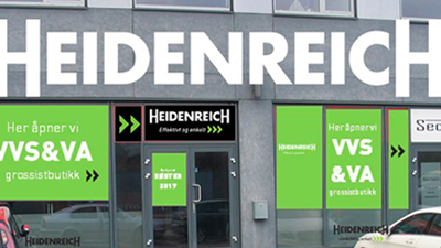 Butikkfasade med navnet "Heidenreich" og informasjon om åpning av VVS & VA grossistbutikk.
