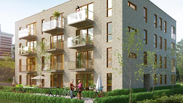 Moderne leilighetsbygg med balkonger, grønne trær og syklister på fortauet.
