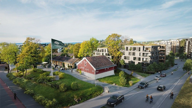 Utsikt over et boligområde med moderne bygninger og en rød bygning omgitt av trær og biler på veien.