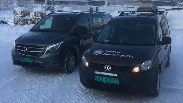 To biler parkert i snøen, en grå Mercedes og en svart Volkswagen, begge med registreringsskilt og logoer.