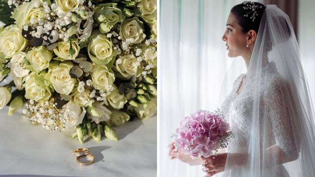 Brud med blomsterbukett og vielsesringer, står ved vinduet i lys kjole og slør.