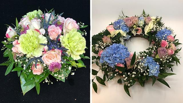 Fargerik blomsterkrans med roser, nelliker og hortensia i pastellfarger på svart bakgrunn.