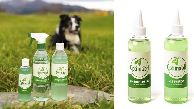 Tre flasker med rengjøringsprodukter fra OptimapH står på gresset, med en hund i bakgrunnen.
