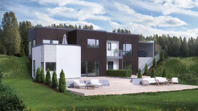 Moderne hus med stor terrasse, grønne plener og trær i bakgrunnen under en blå himmel.