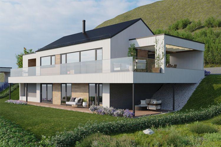 Moderne hus med stor terrasse, glassrekkverk og grønt landskap i bakgrunnen.